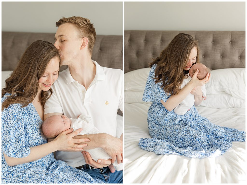 Husband kissing wife as she smiles down at her baby girl.