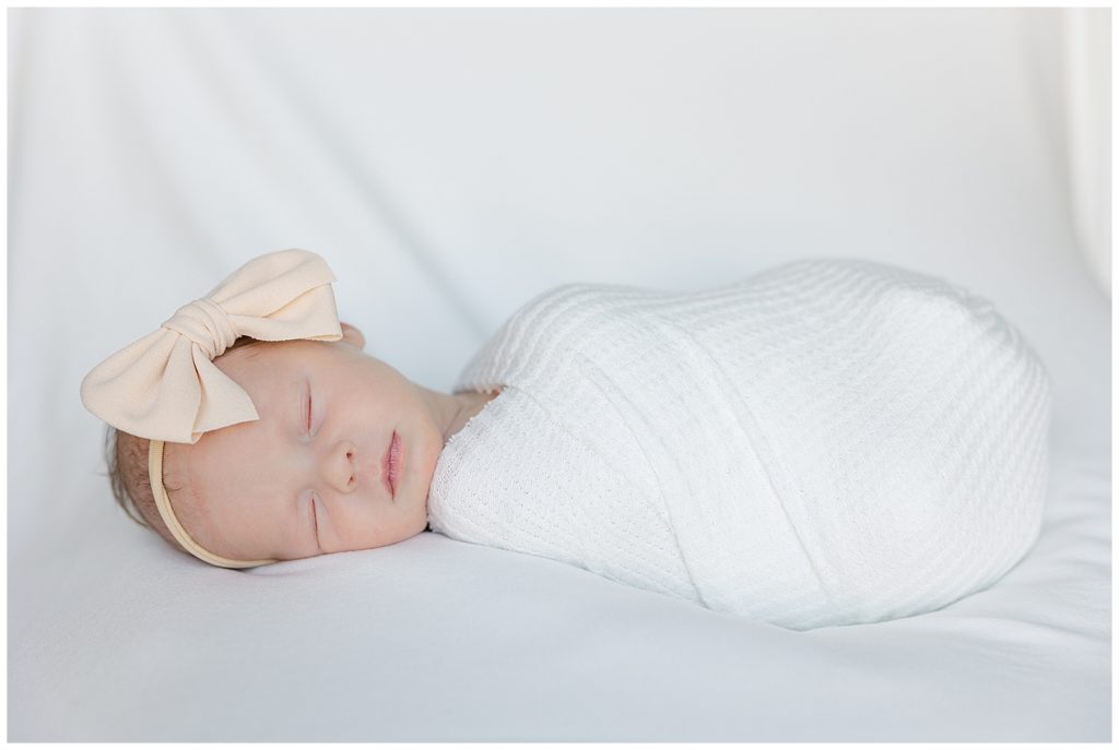 Individual portrait of newborn wrapped up and sleeping.